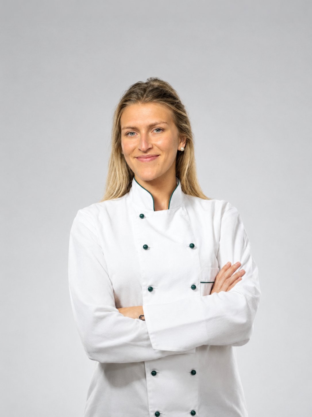 Chef Marek in her chef's whites, smiling with arms crossed.
