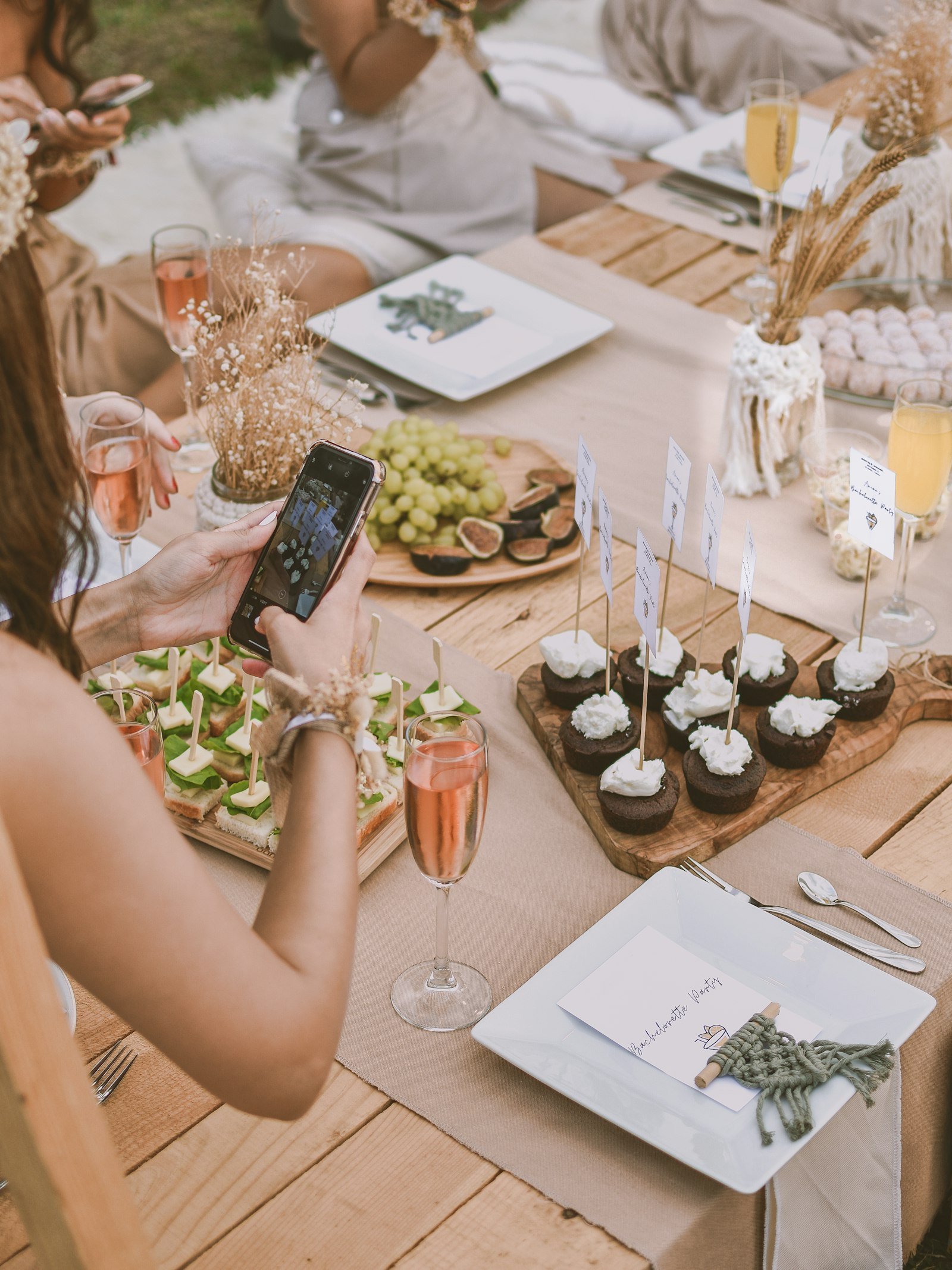 A rustic picnic setup with gourmet dishes and a scenic outdoor backdrop.